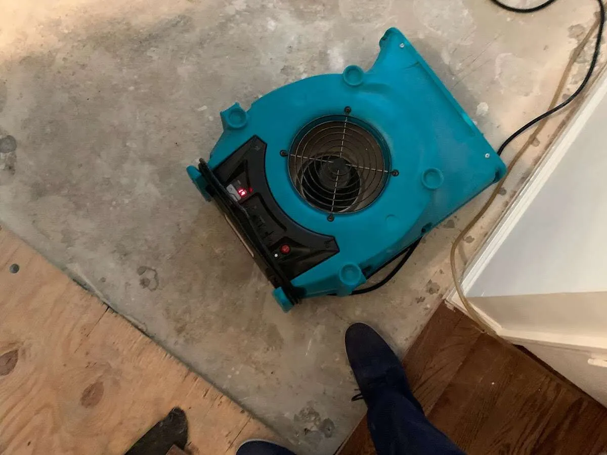 Air mover drying subfloor during Commercial Water Damage Restoration in Nantucket